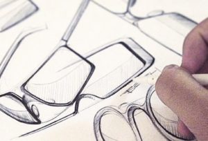 Industrial designer sketching glasses with pen and paper