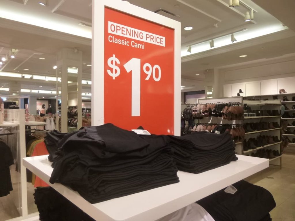 A red retail sign showing how cheap fast fashion can be.