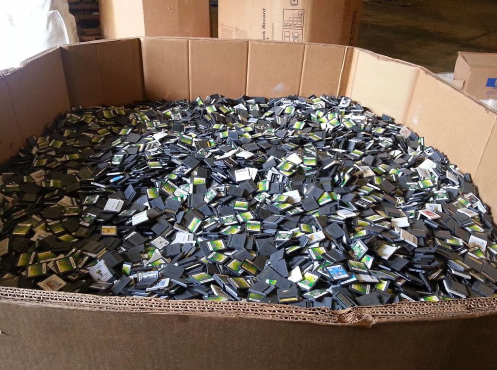 A large crate of Nintendo DS games being thrown away.