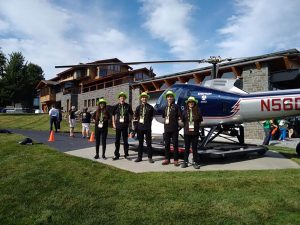 Dean Kamen next to his helicopter and house