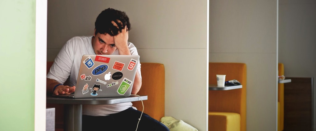 Student grabbing his hair out of frustration trying to learn new software