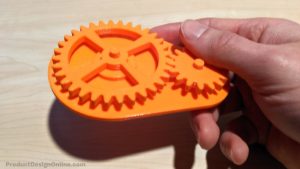 A hand holding a 3D Printed gear drive designed in Autodesk Fusion 360